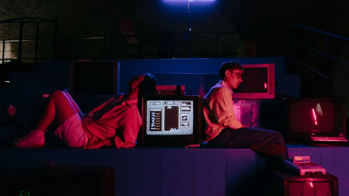 Teenagers playing video games in front of vintage monitors