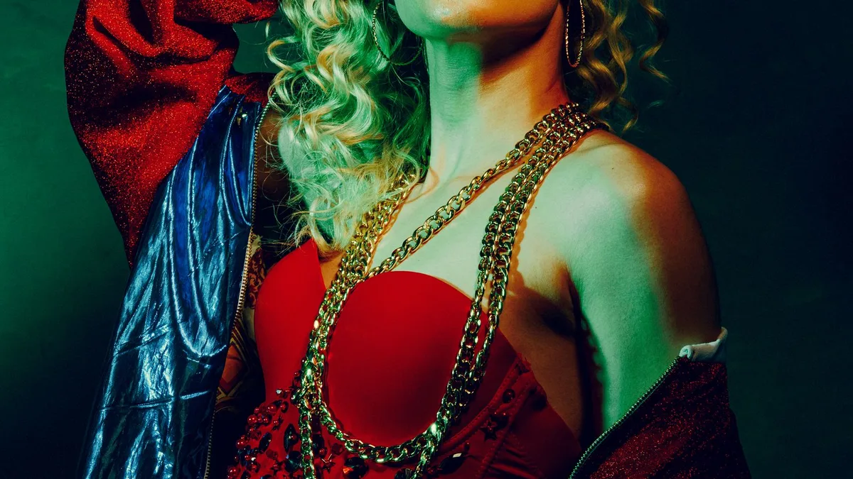 A model in bold 1980s fashion with colourful studio lighting