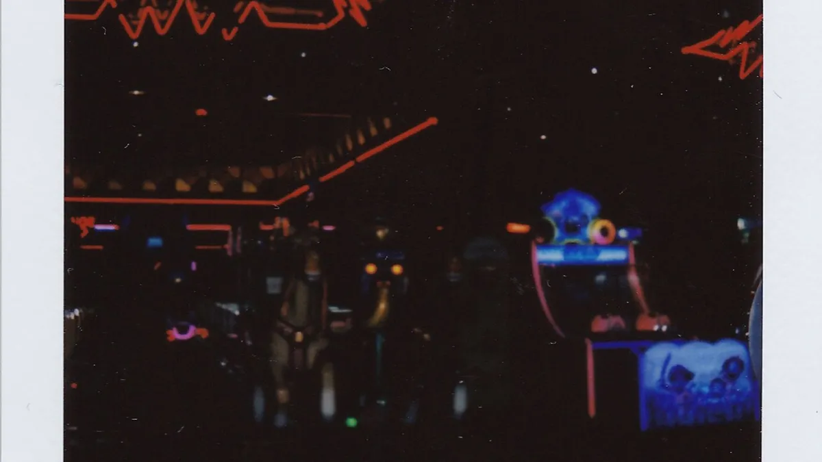 Neon lights glowing in a dark arcade interior