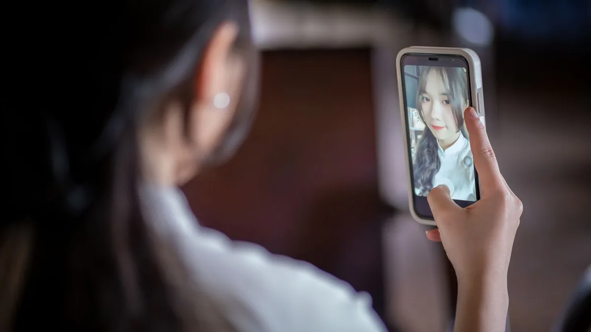 A phone showing an original photo next to its 80s-filtered result, mid-comparison