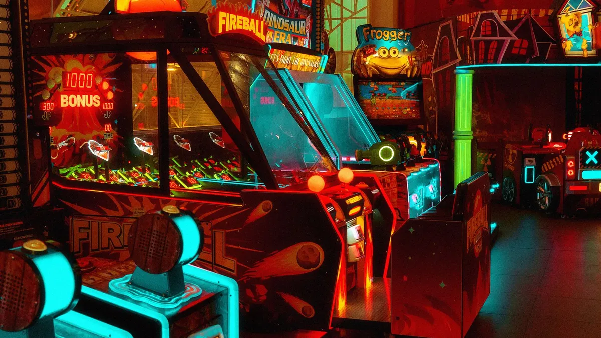 A colourful neon-lit arcade full of game machines