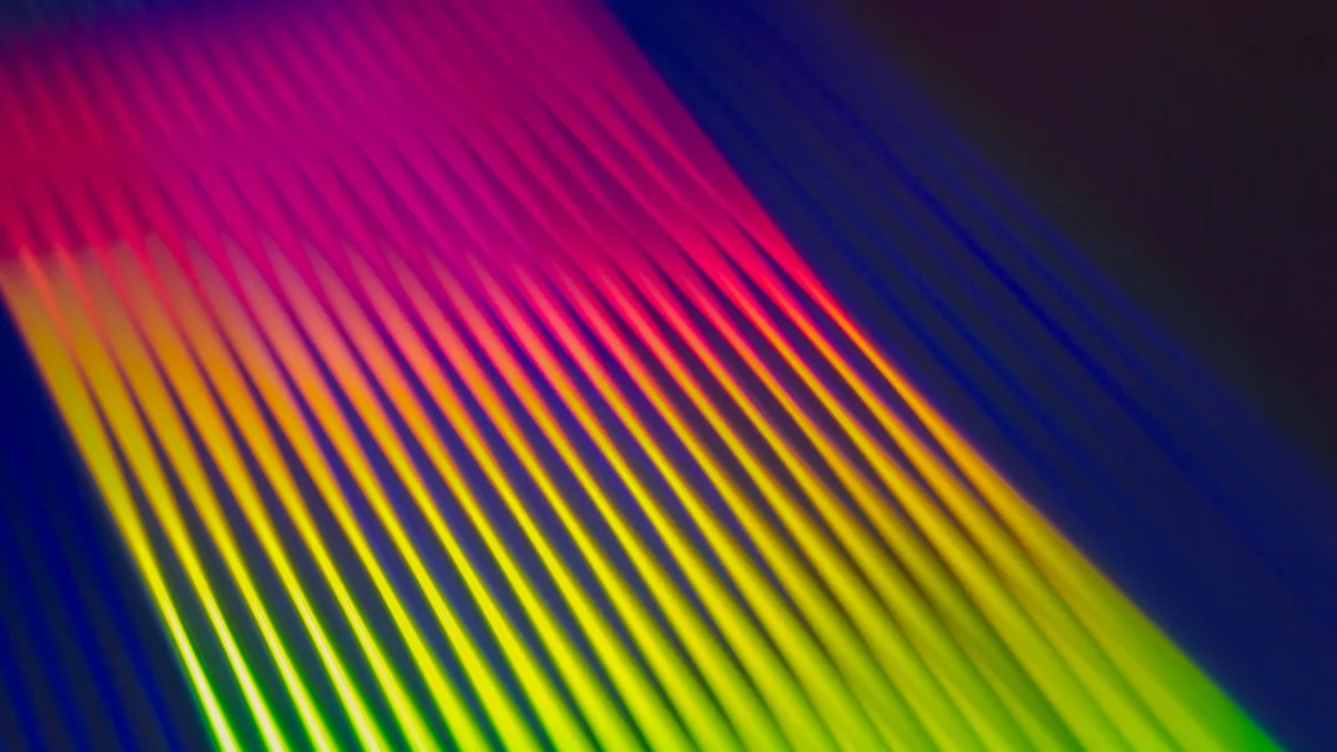 A vivid neon gradient of abstract colour stripes