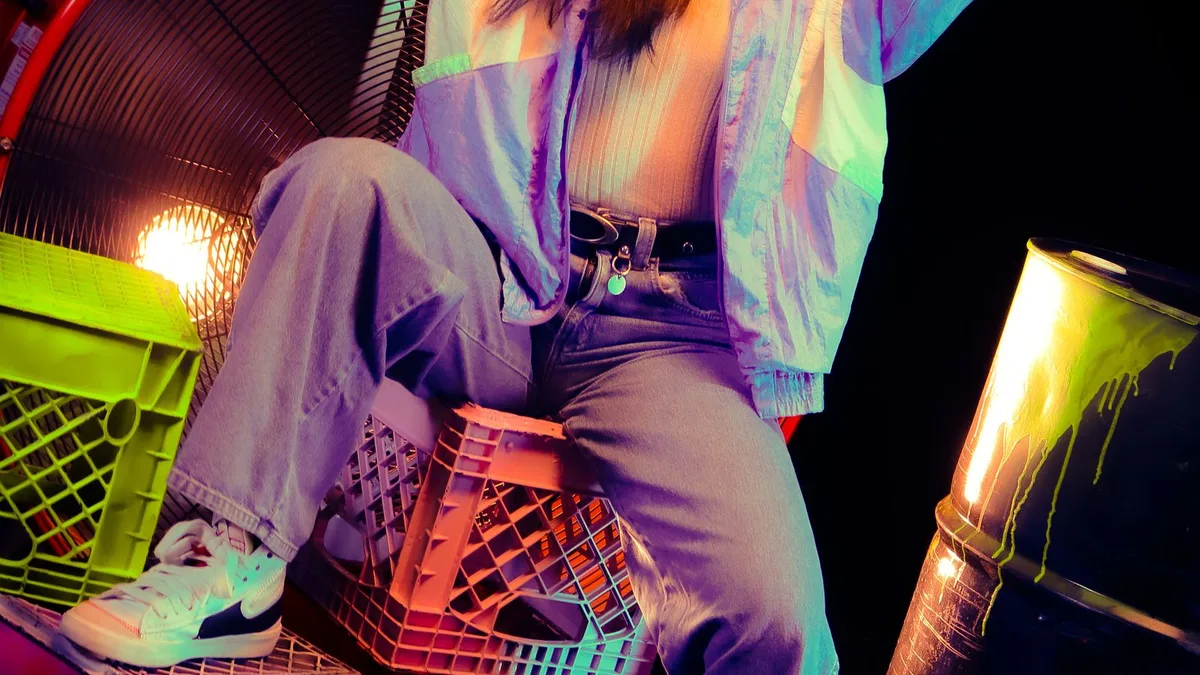 A woman posing under vibrant neon lighting in an 80s-style photo