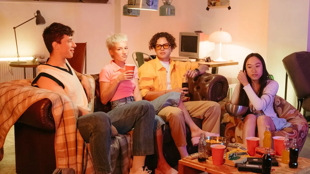 Teenagers hanging out in a retro living room